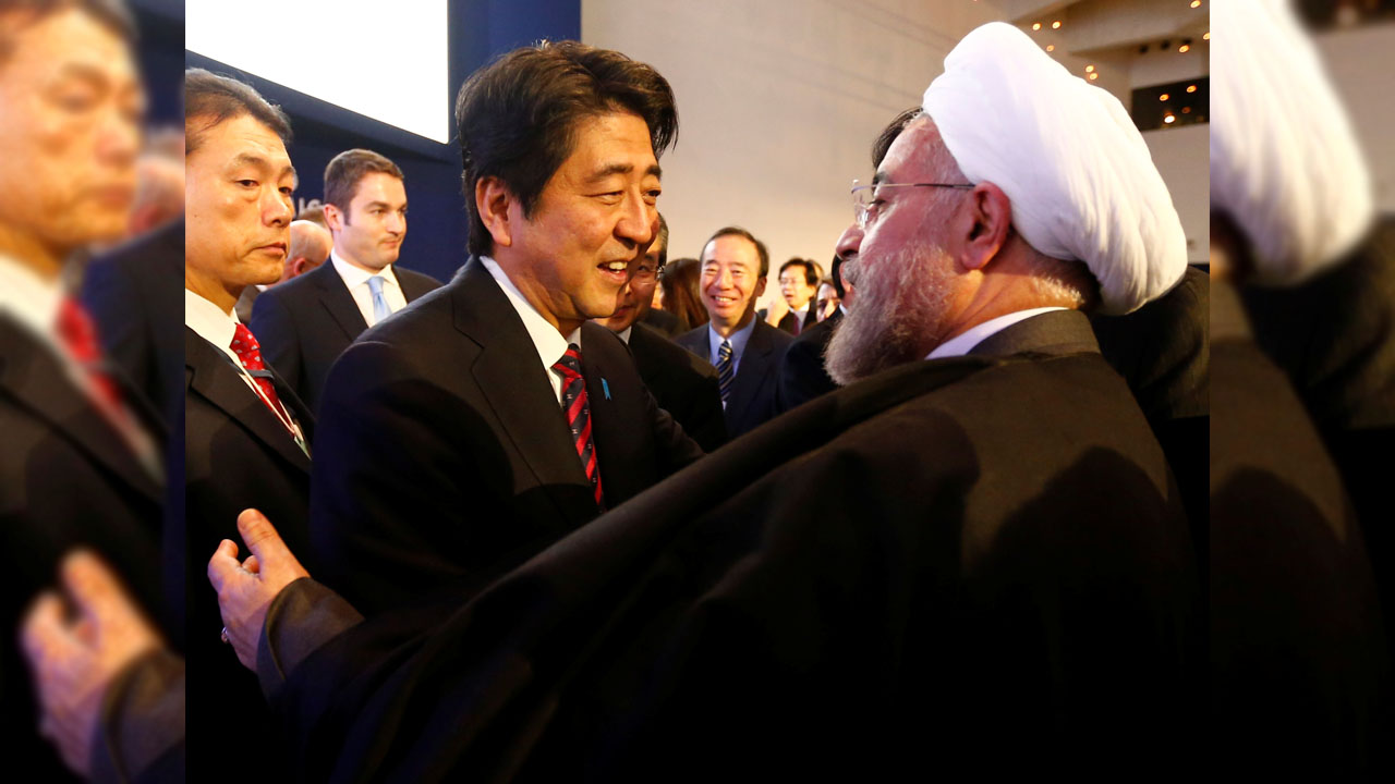 FILE PHOTO: Japan’s Prime Minister Abe greets Iran’s President Rouhani  at World Economic Forum in Davos