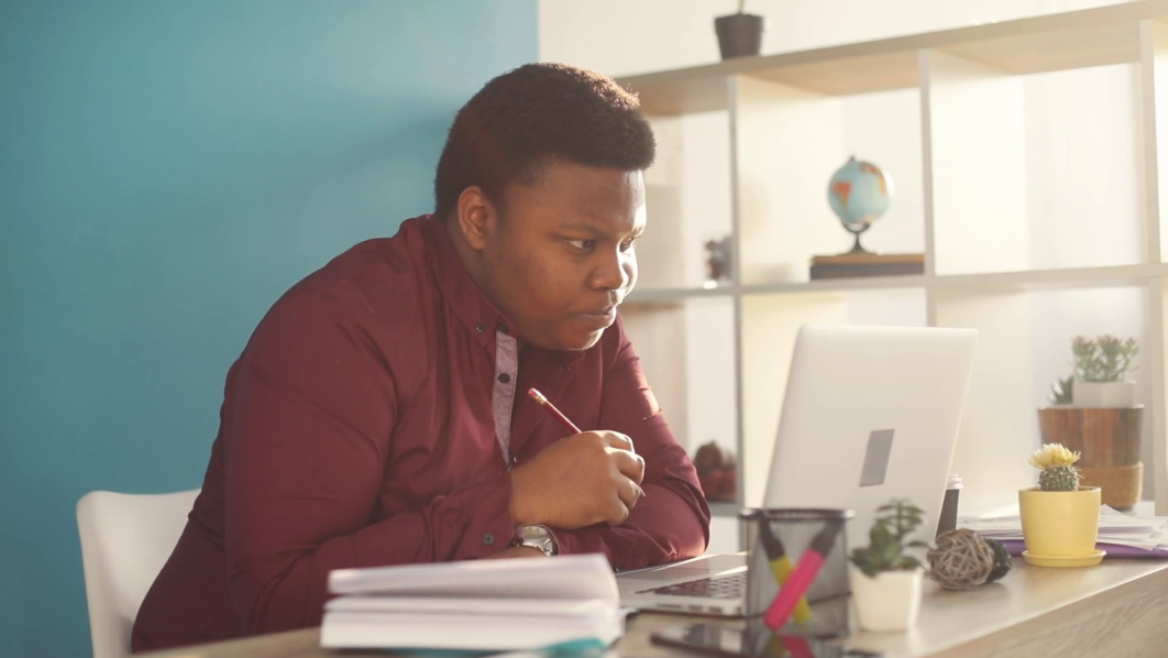 Concentrated man studying on his system. Photo Video Blocks