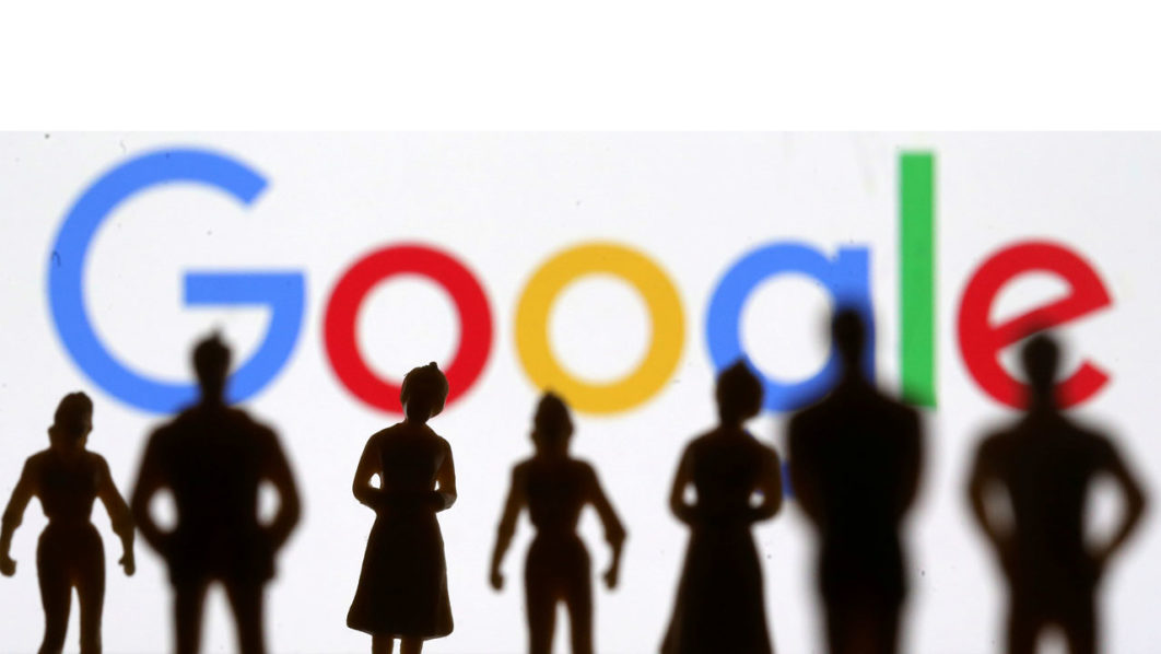 FILE PHOTO: Small toy figures are seen in front of Google logo in this illustration picture