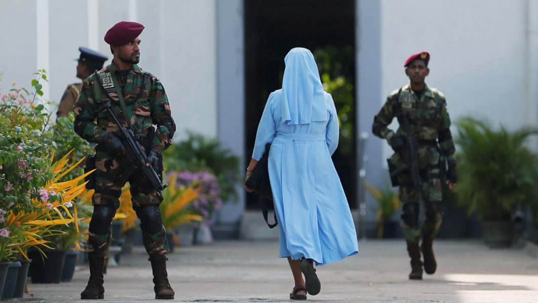 FILE PHOTO: A nun arrives as a Sri Lanka’s commando soldier stands guard in front of the main entrance to St. Lucia Cathedral as survivors and families of victims of Sri Lanka’s Easter Sunday bombing arrive for a special mass for those who lost their live