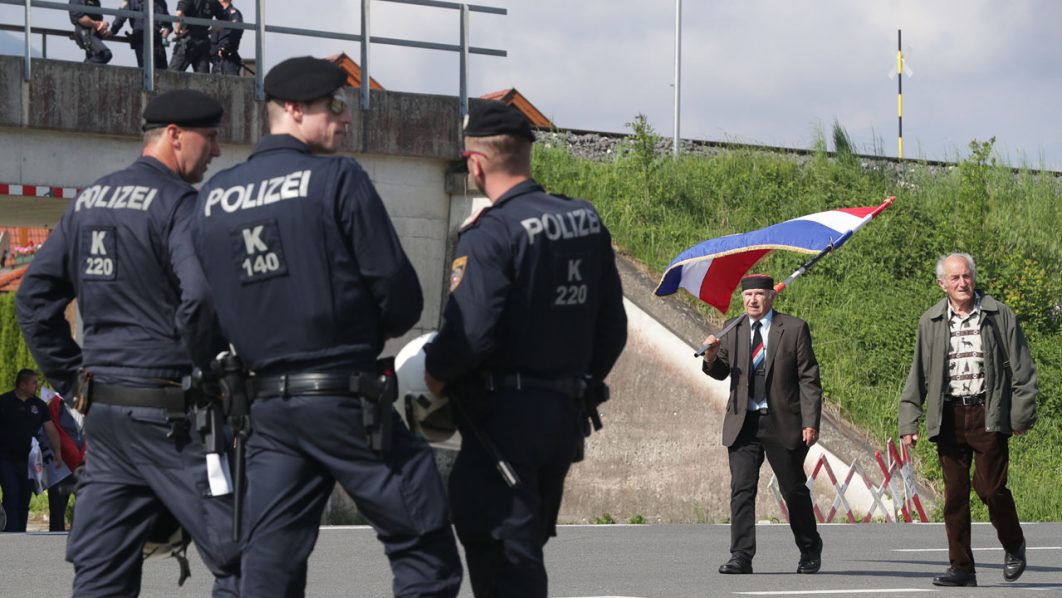 Police watch participants arriving at a Catholic ceremony commemorating the turning away from Austria of pro-Nazi Croatians at the end of World War Two in Bleiburg