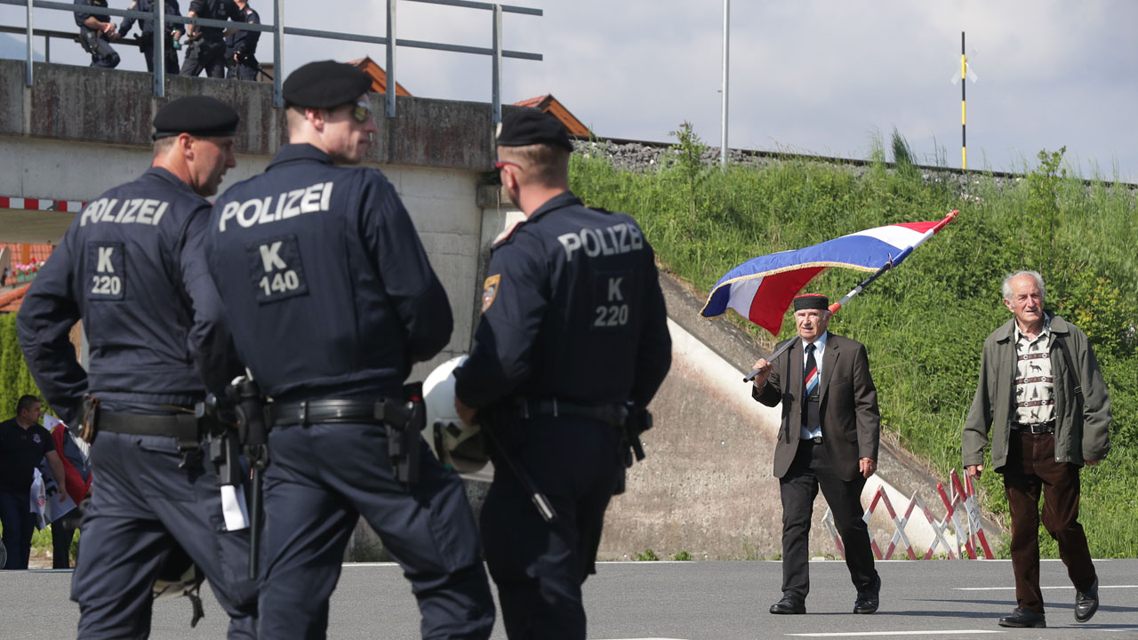 Police watch participants arriving at a Catholic ceremony commemorating the turning away from Austria of pro-Nazi Croatians at the end of World War Two in Bleiburg