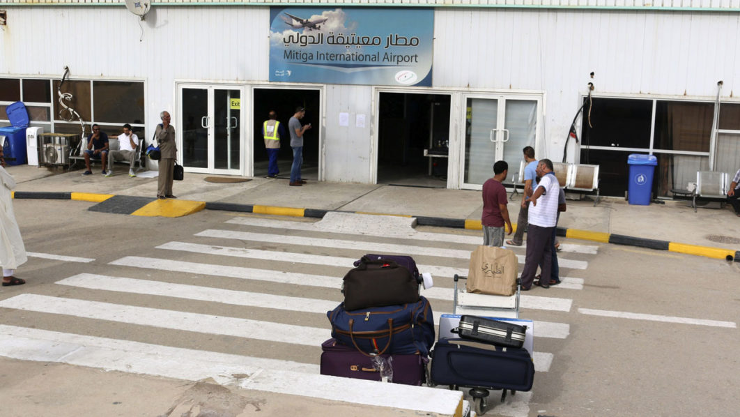 Passengers are seen in front of Tripoli’s Mitiga airport, after clashes between rival militias closed down Tripoli International Airport