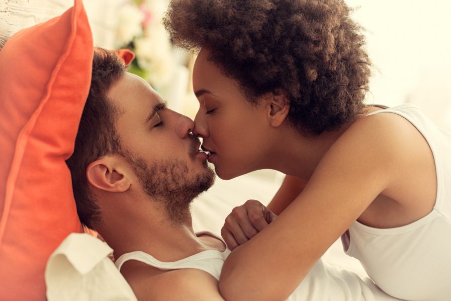Couple Kissing in Bed