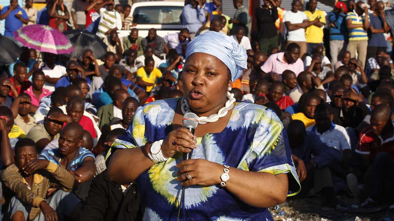 South Africa’s Minister of Defence Nosiviwe Mapisa-Nqakula addresses striking miners outside a South African mine in Rustenburg