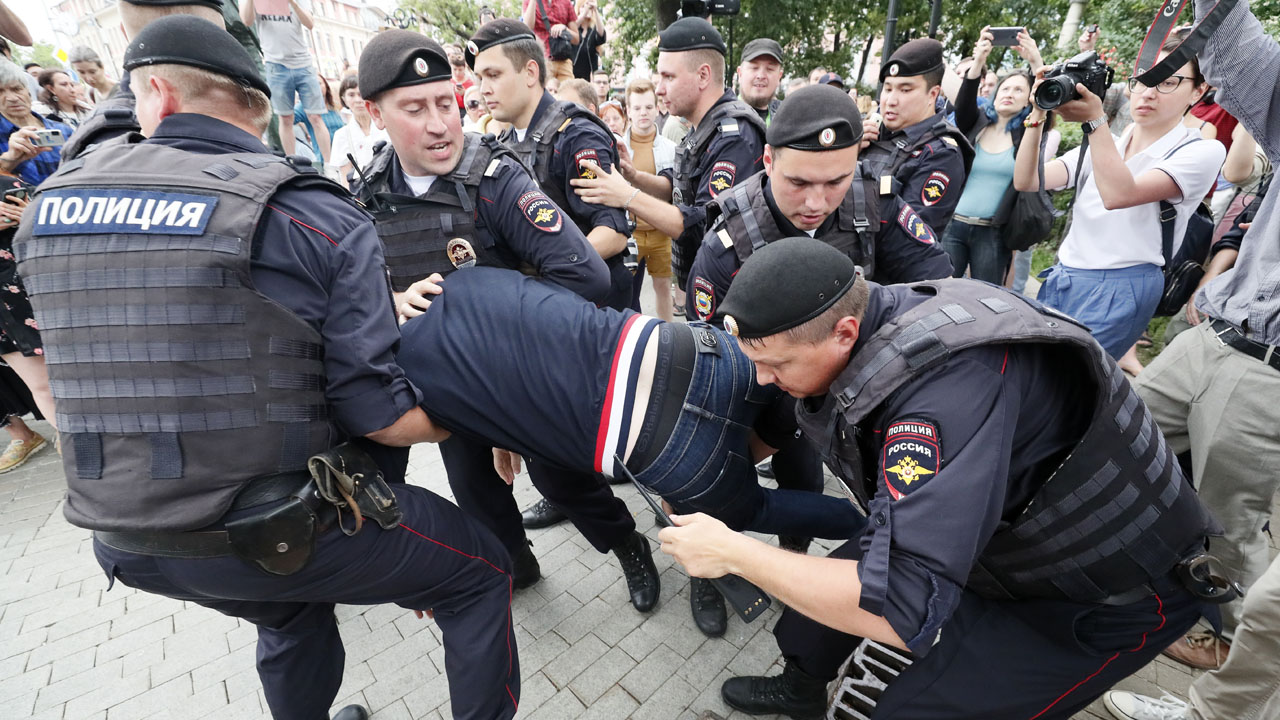Law enforcement officers detain a participant of a rally in support of Russian investigative journalist Ivan Golunov in Moscow