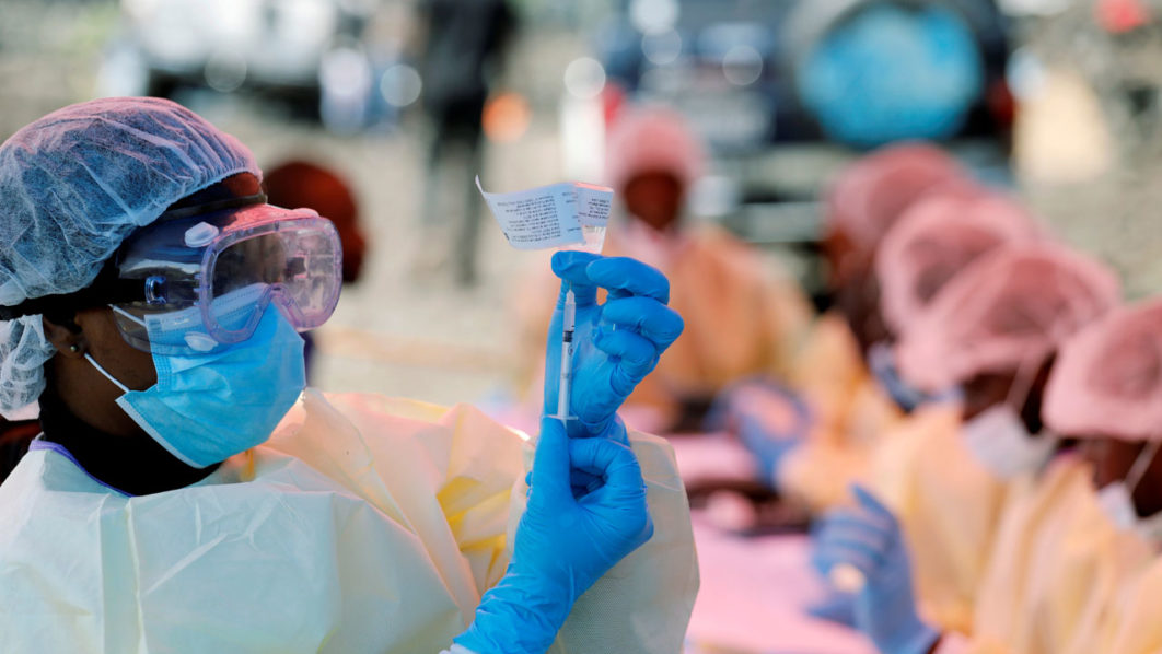 FILE PHOTO: A health worker fills a syringe with Ebola vaccine before injecting it to a patient, in Goma