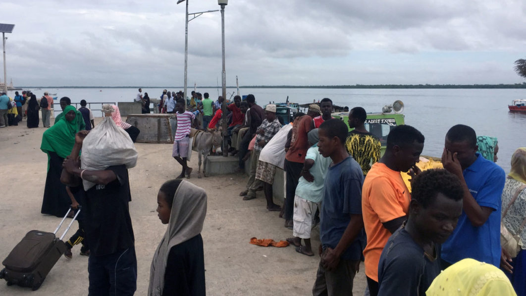 Travellers are seen gathered at the Lamu jetty following an attack by Somalia’s Islamist group al Shabaab on a military base in Manda, Lamu