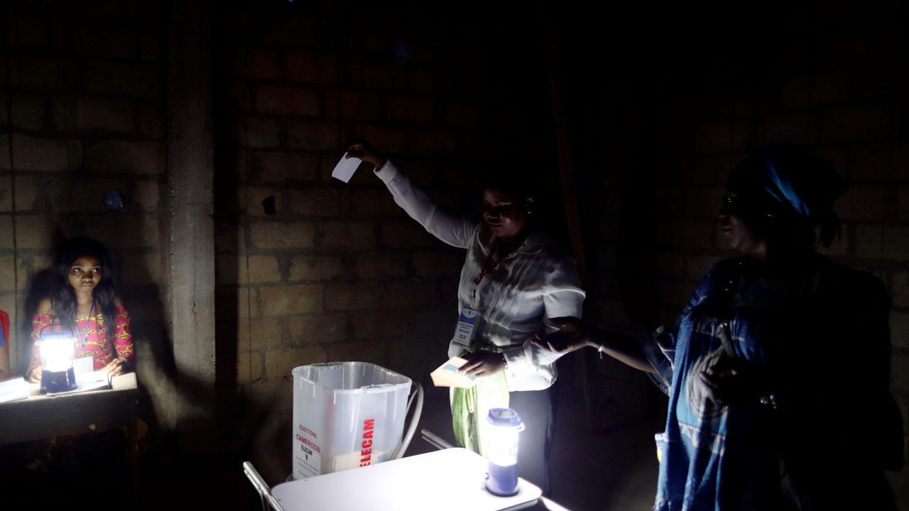 Election workers take part in vote counting during the presidential election in Yaounde,