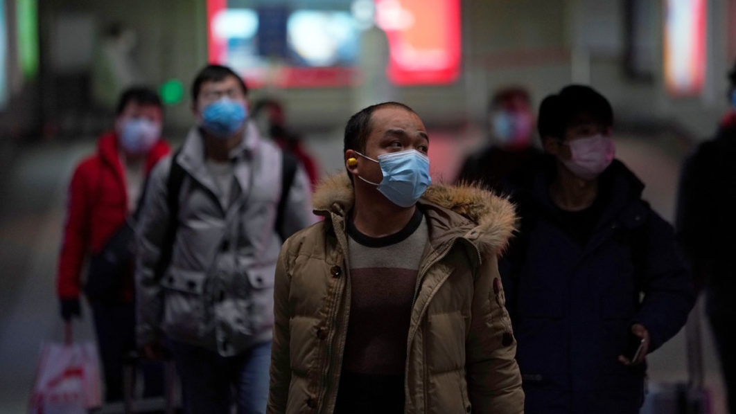 People wearing masks are seen at a subway station in Shanghai