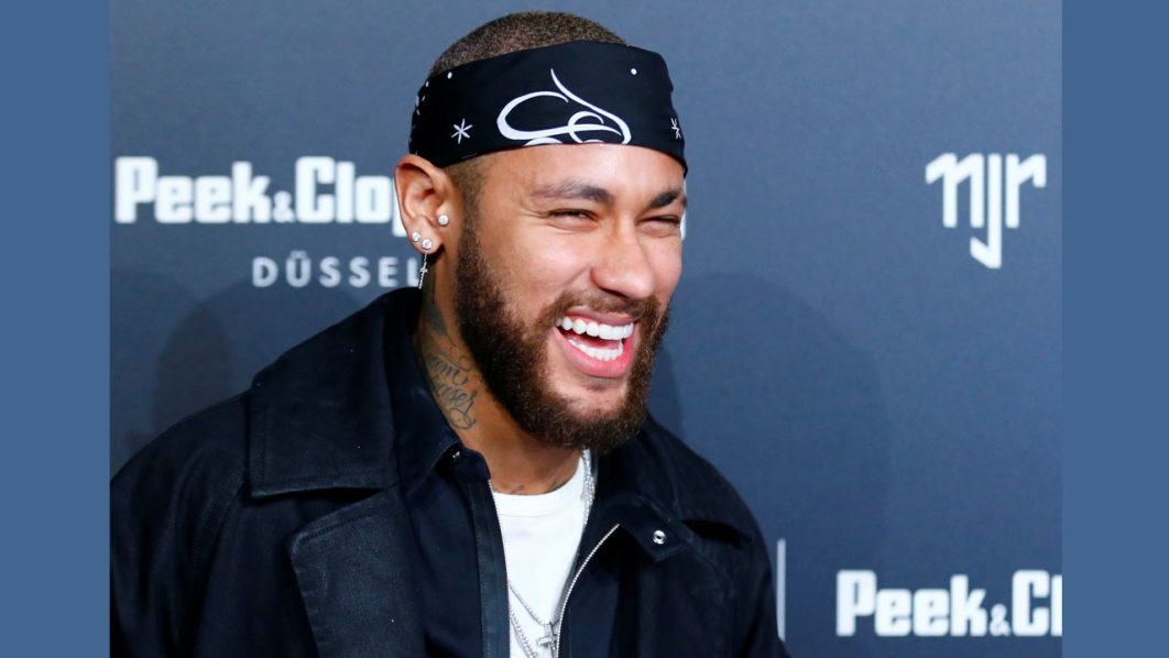 Brazilian football player Neymar of Paris St Germain poses as he arrives at an after show party following the launch event for the new Capsule Collection