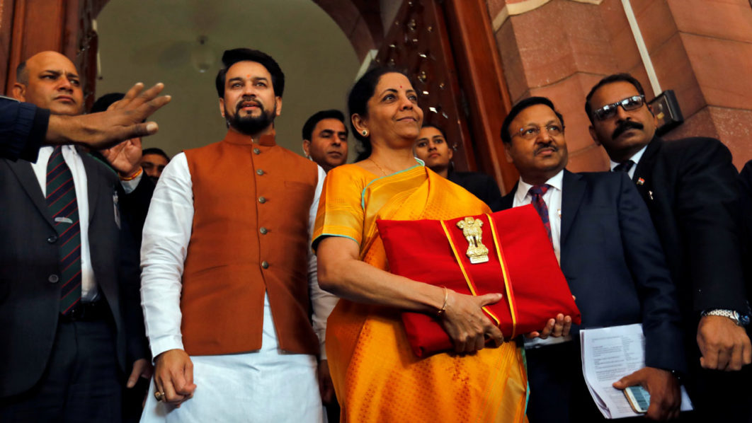 India’s Finance Minister Nirmala Sitharaman is flanked by junior Finance Minister Anurag Thakur as she arrives to present the budget in Parliament in New Delhi