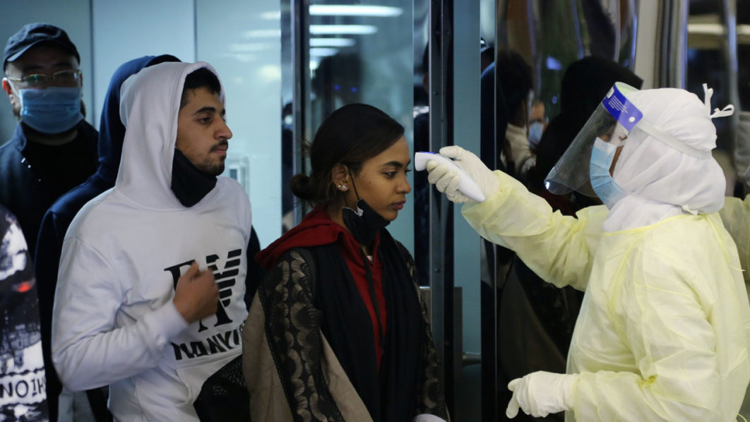 Passengers coming from China wearing masks to prevent a new coronavirus are checked by Saudi Health Ministry employees upon their arrival at King Khalid International Airport, in Riyadh