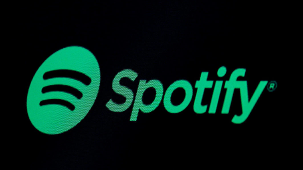 FILE PHOTO: The Spotify logo is displayed on a screen on the floor of the NYSE in New York