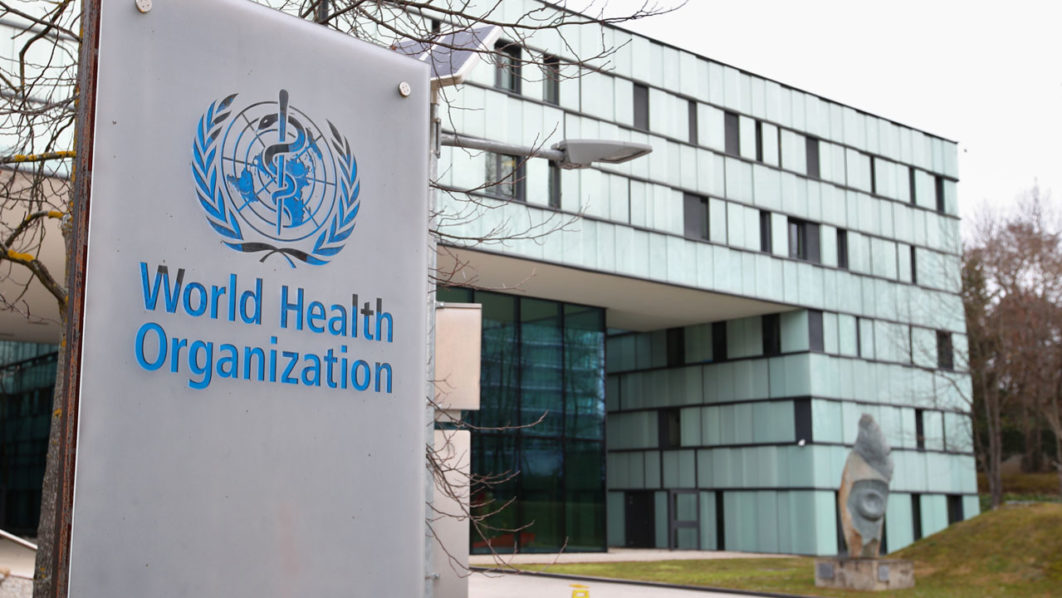 A logo is pictured outside a building of the WHO in Geneva