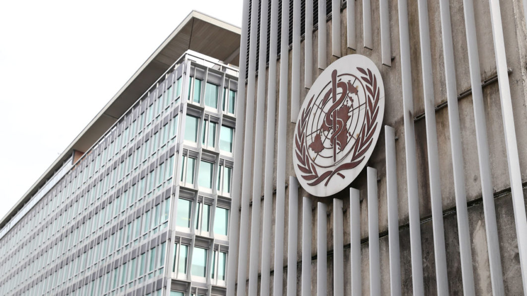 A logo is pictured on the headquarters of the WHO in Geneva