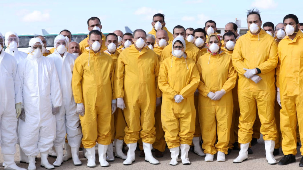 Egyptian Minister of Health Hala Zayed stands with a medical team at Borg El Arab airport, awaiting passengers that were evacuated from Wuhan, China, in Alexandria