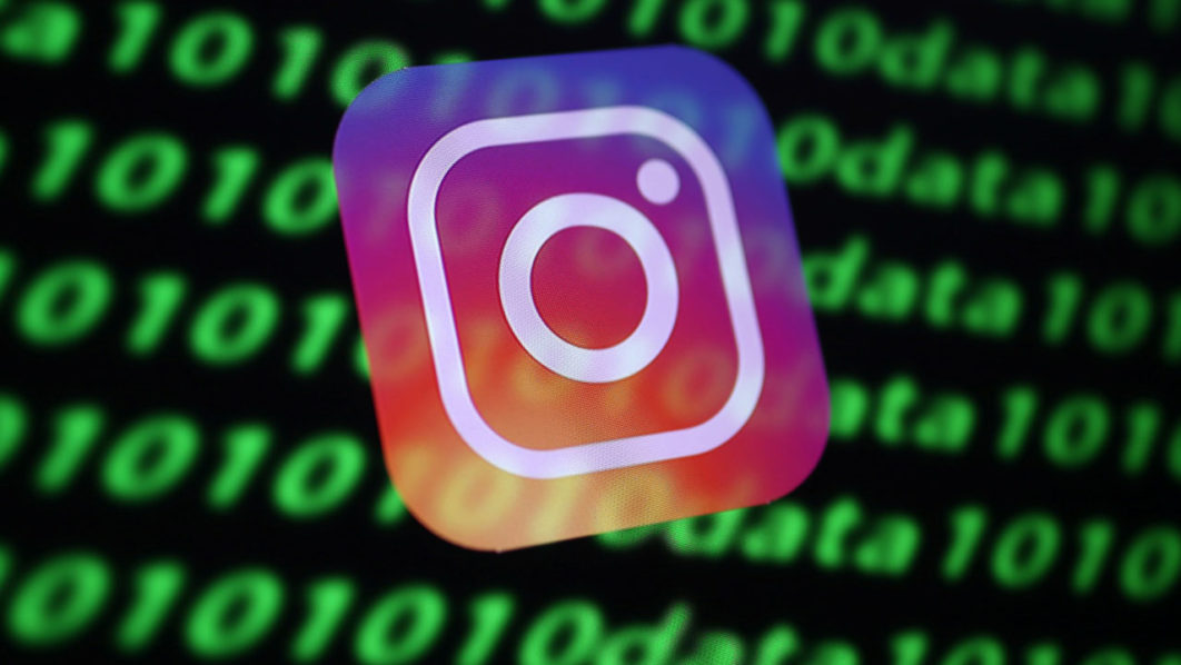 The Instagram logo and binary cyber codes are seen in this illustration
