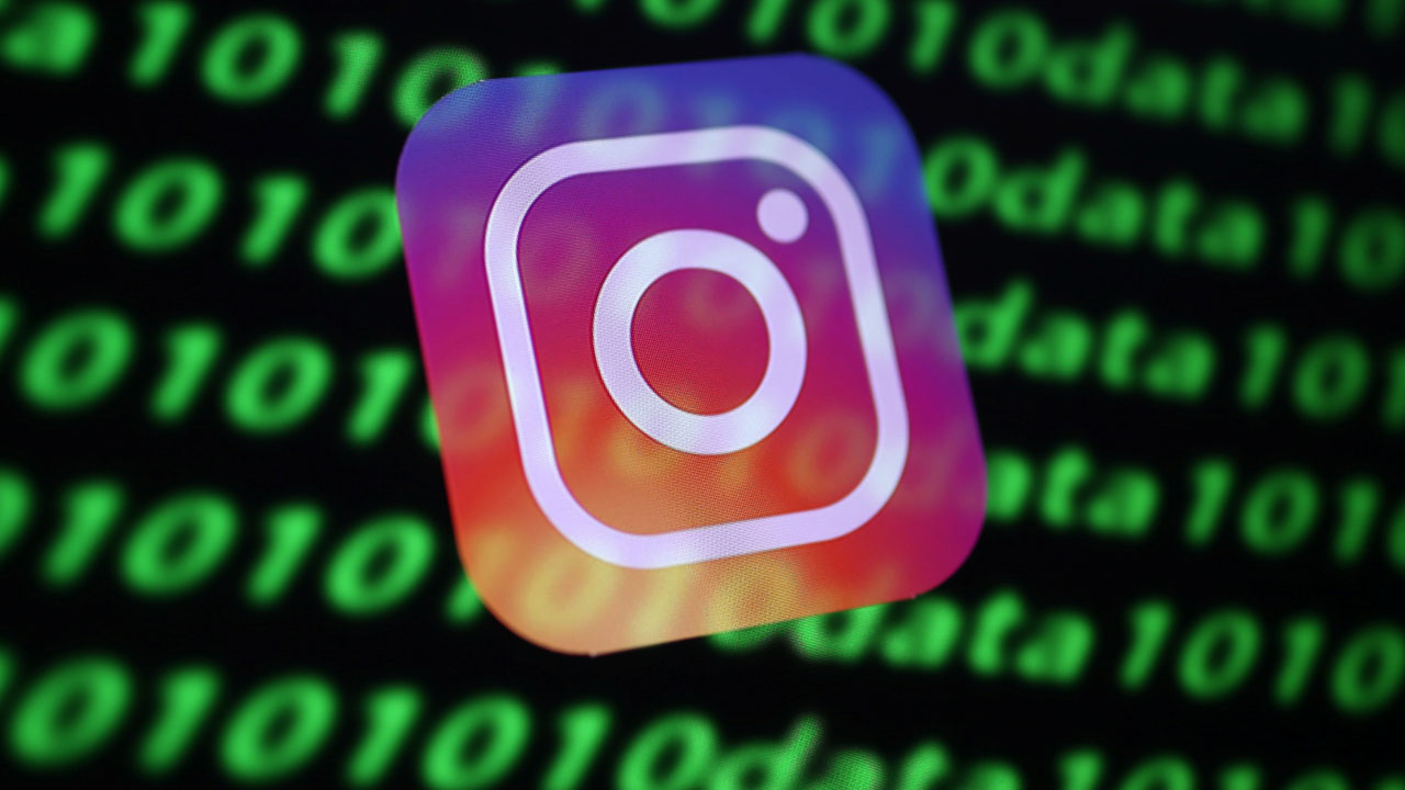 The Instagram logo and binary cyber codes are seen in this illustration