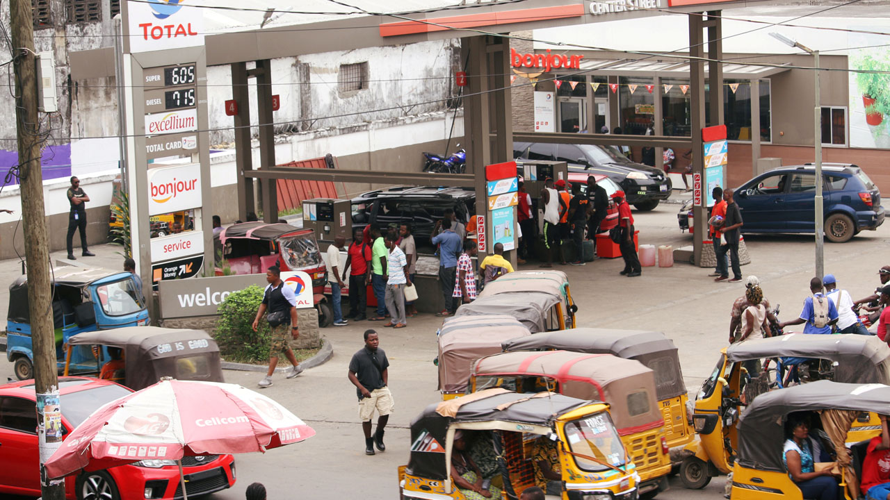FILE PHOTO: Motorcycle taxis, called kekeh in Liberia, stand in line waiting to refuel at gas station amid shortages of supplies in Monrovia