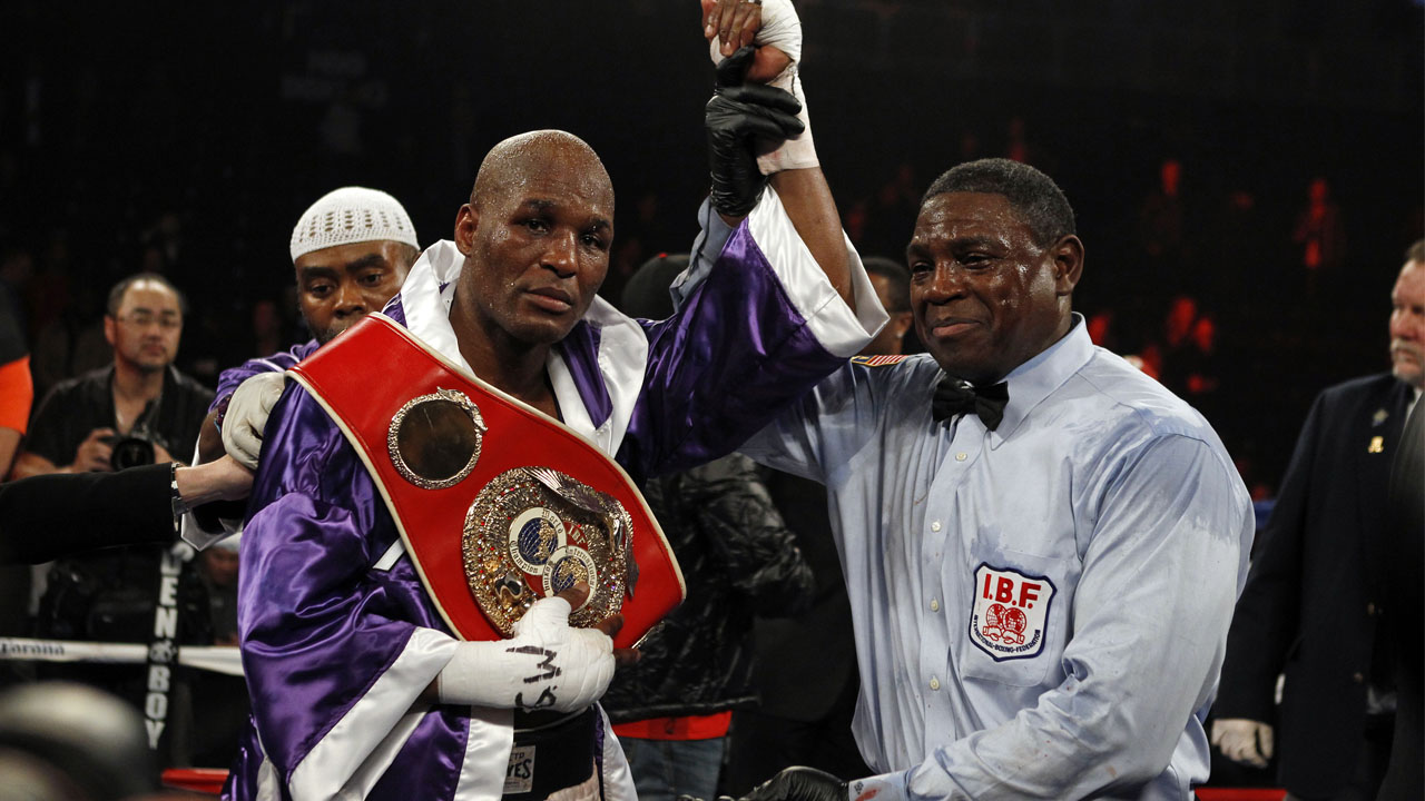 Hopkins poses for a photo with referee Brown after defeating Cloud in their IBF light heavyweight title in New York