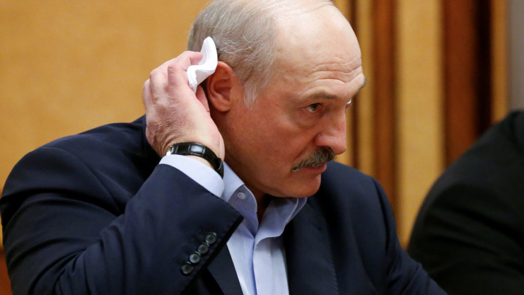 FILE PHOTO: Belarusian President Alexander Lukashenko listens to Russian President Vladimir Putin during their meeting in the Black sea resort of Sochi