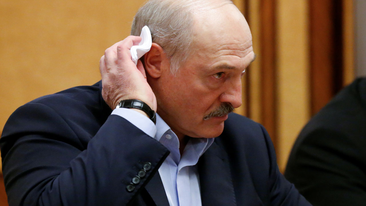 FILE PHOTO: Belarusian President Alexander Lukashenko listens to Russian President Vladimir Putin during their meeting in the Black sea resort of Sochi