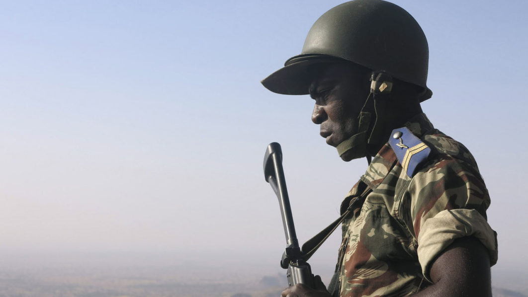 A Cameroonian soldier stands guard at an observation post on a hill in the Mandara Mountain chain in Mabass overlooking Nigeria