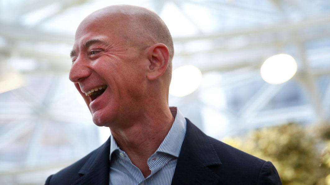 FILE PHOTO: Amazon founder and CEO Jeff Bezos laughs as he talks to the media while touring the new Amazon Spheres during the grand opening in Seattle