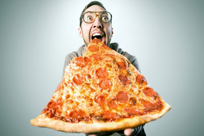A man holding pizza