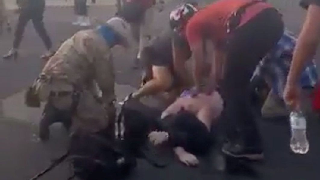 Attendees help a man who was shot and wounded in Albuquerque