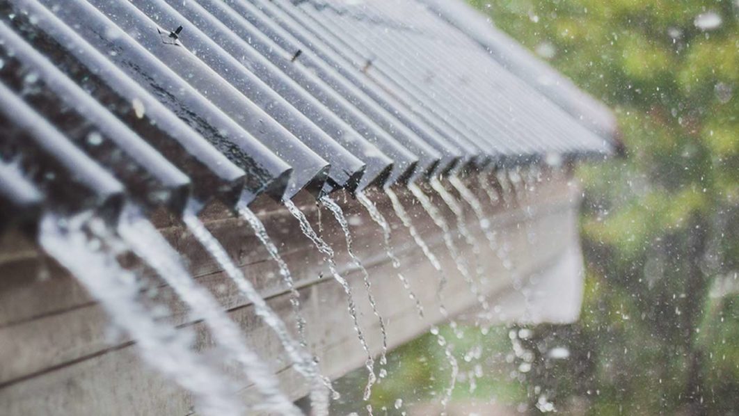 shingles+with+rain+pouring+off+of+them+because+heavy+rain+impacts+your+roof