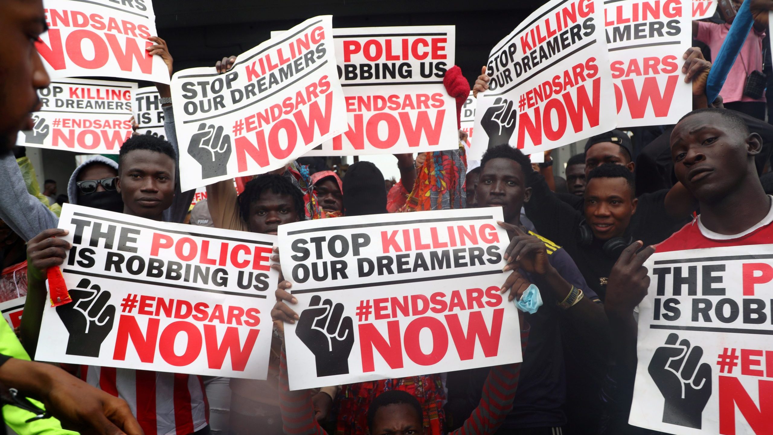 FILE PHOTO: Demonstrators carry banners during a protest over alleged police brutality, in Lagos
