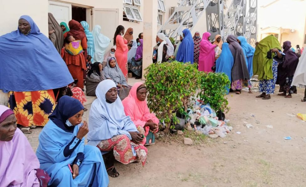 Some-women-hanging-outside-the-1000-seater-Lecture-Theatre-Kaduna-State-University-venue-of-the-ongoing-disbursement-of-N20000-grant-to-women-by-Federal-Government-in-Kaduna-State.