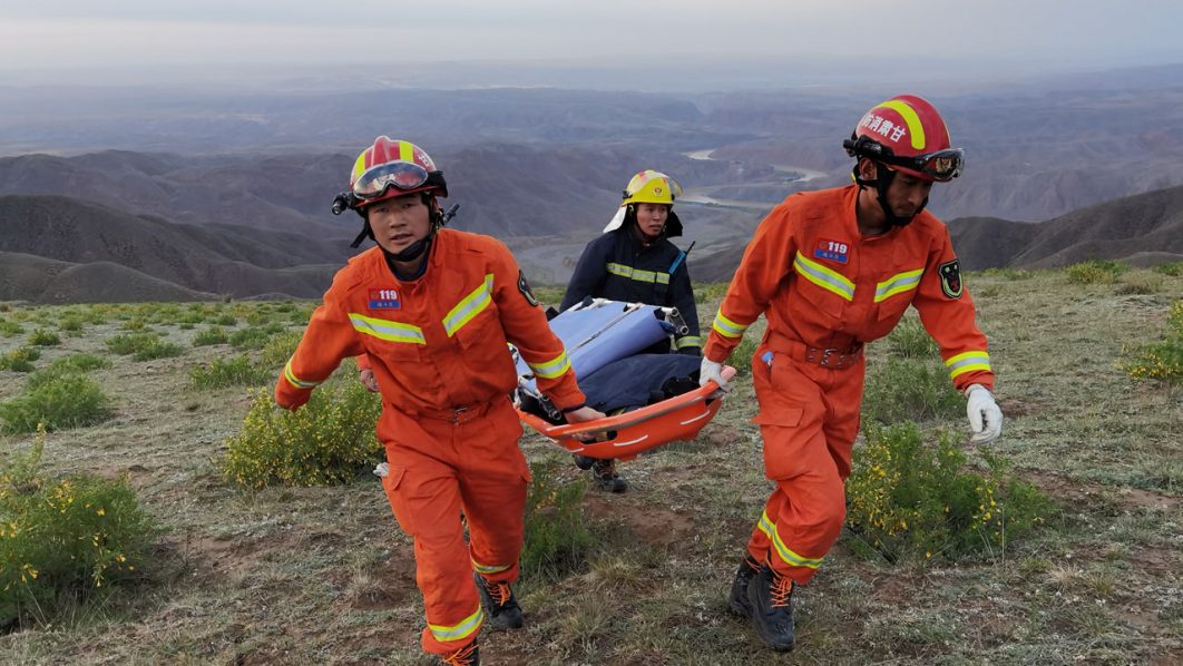 Rescue workers work at the site of the accident where extreme cold weather killed participants of an 100-km ultramarathon race in Baiyin
