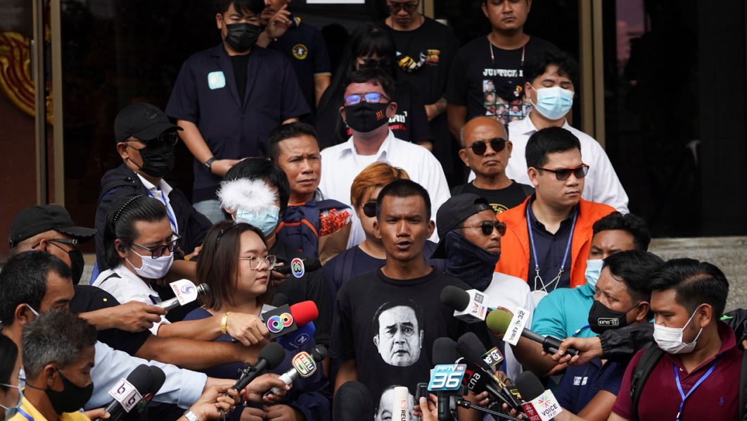 Anti-government protesters leaders Panusaya “Rung” Sithijirawattanakul, Panupong “Mike” Jadnok, and Jatupat “Pai” Boonpattararaksa arrive to report themselves over royal insult charges, at the Attorney General’s office in Bangkok