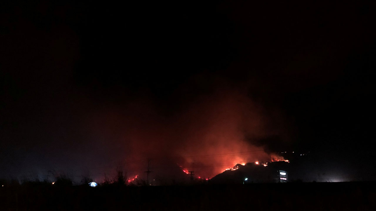 Flames rise as a wildfire burns on a hill in Kamloops
