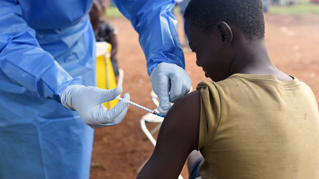 FILE PHOTO: A Congolese health worker administers Ebola vaccine to a boy who had contact with an Ebola sufferer in the village of Mangina