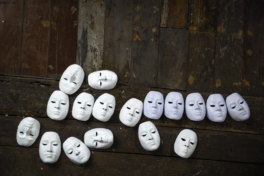 15417632 – abstract white masks on wooden background