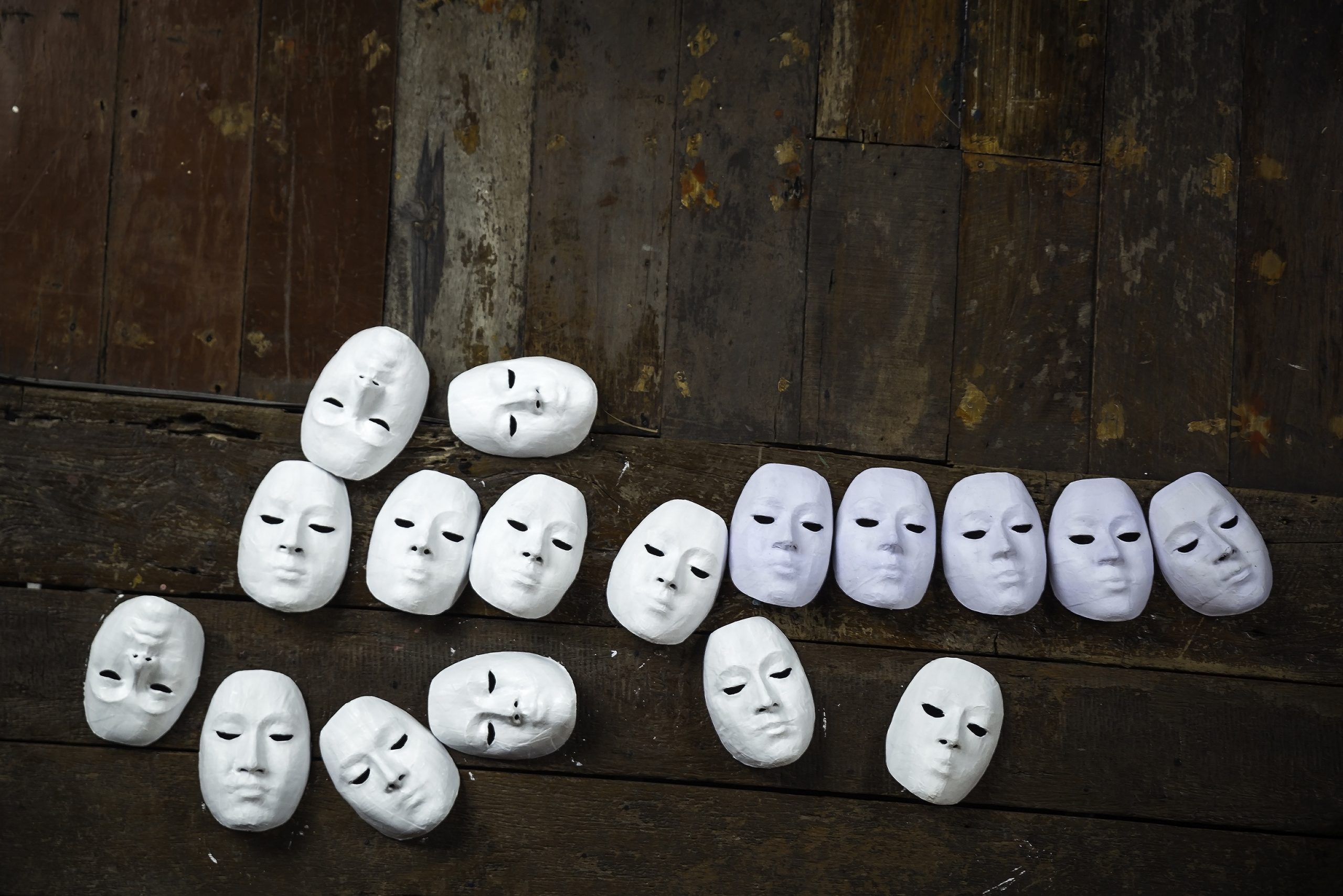 15417632 – abstract white masks on wooden background