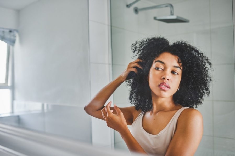 woman checking for zit GettyImage (1)