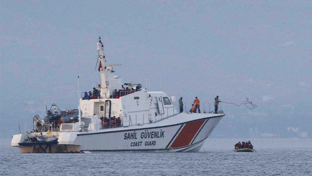 A line is thrown from a Turkish Coast Guard ship off the shores of Bodrum, Turkey, as migrants in a dinghy paddle on the Mediterranean Sea in a failed attempt to cross to Greece