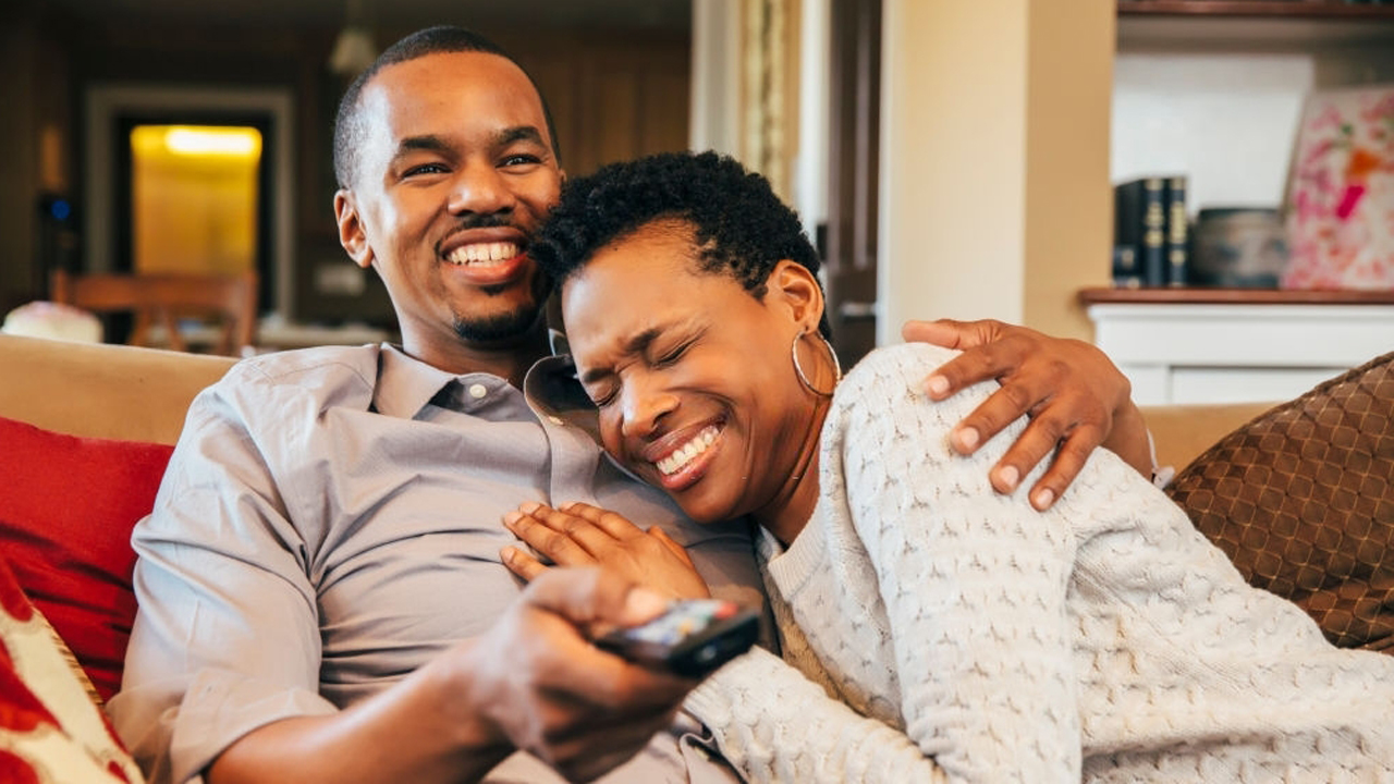Couple-loved-up-in-front-of-a-TV-Photo-Getty-Images