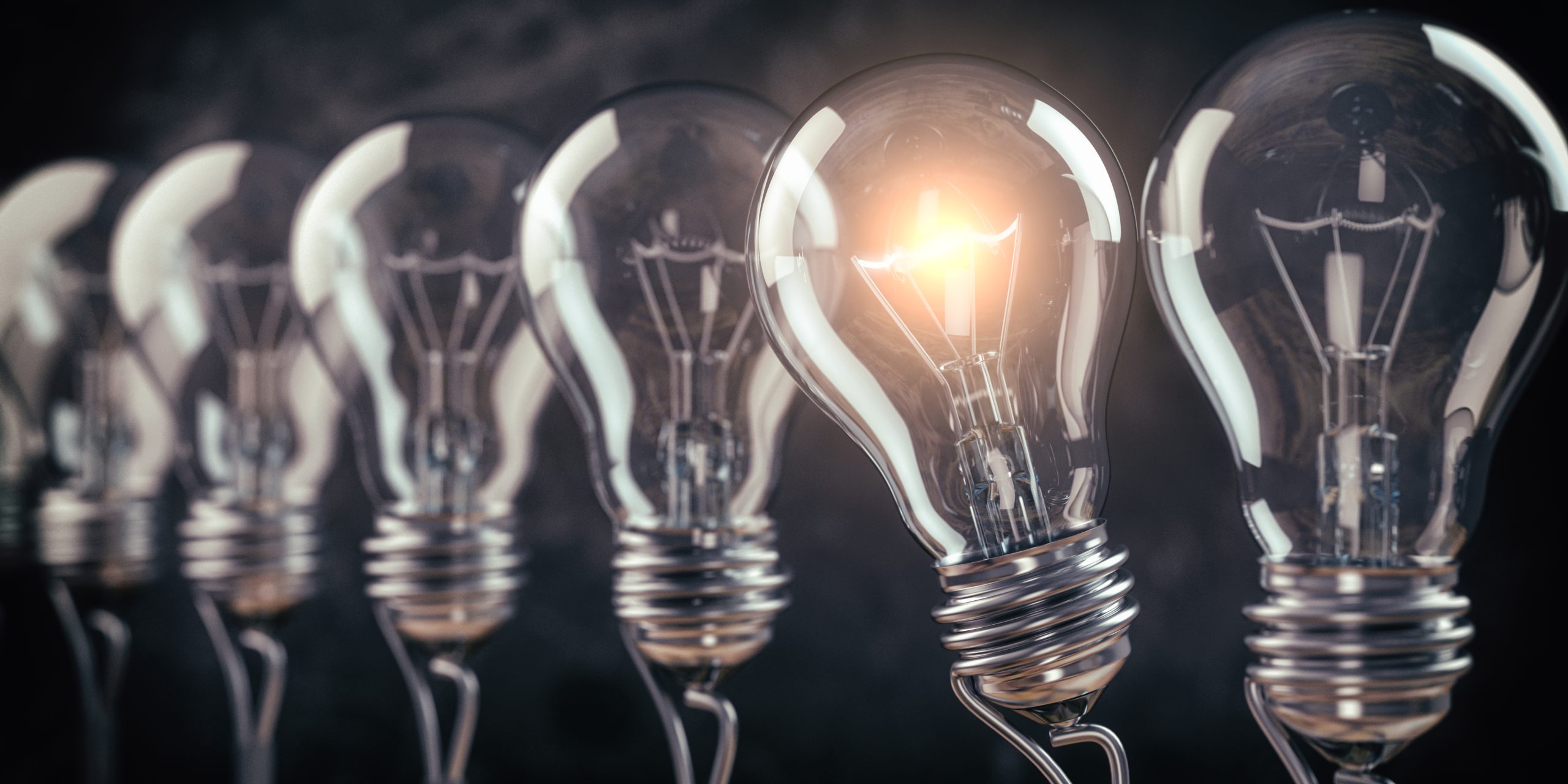 Row of light bulb with a one glowing. Idea and innovation concep