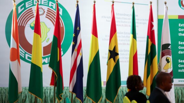 Flags of Economic Community of West African States Commission (ECOWAS) countries are displayed inside the Nigeria presidential villa, after the extraordinary session of Economic Community of West African States (ECOWAS) Heads of State and Government in Abuja, Nigeria on February 24, 2024. - ECOWAS announced on February 24, 2024 that they have lifted the sanctions on Mali, Niger and Burkina Faso. (Photo by Kola Sulaimon / AFP)