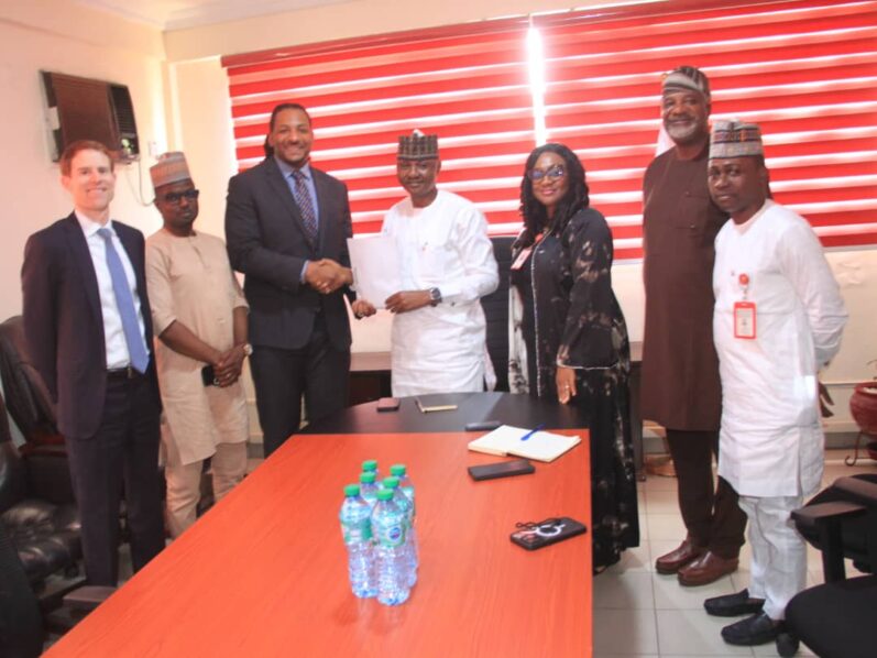 Acting Director, Lagos Zonal Command of the EFCC, Michael T. Wetkas handing over the recovered fund to FBI operatives