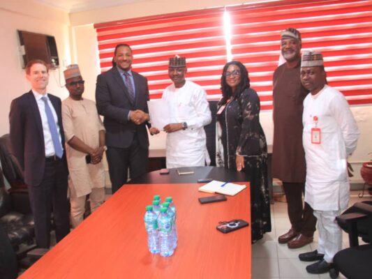 Acting Director, Lagos Zonal Command of the EFCC, Michael T. Wetkas handing over the recovered fund to FBI operatives