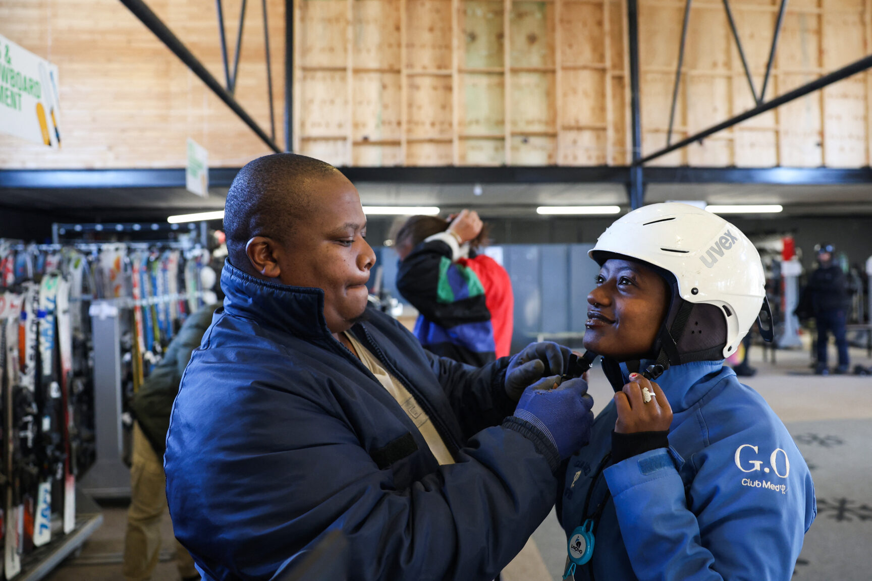Image of a young man assisting a woman with her costume