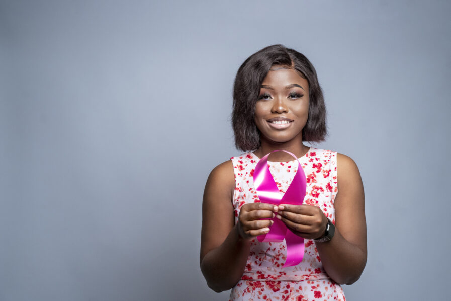 African-American woman holding a ribbon – the concept of world cancer campaign support