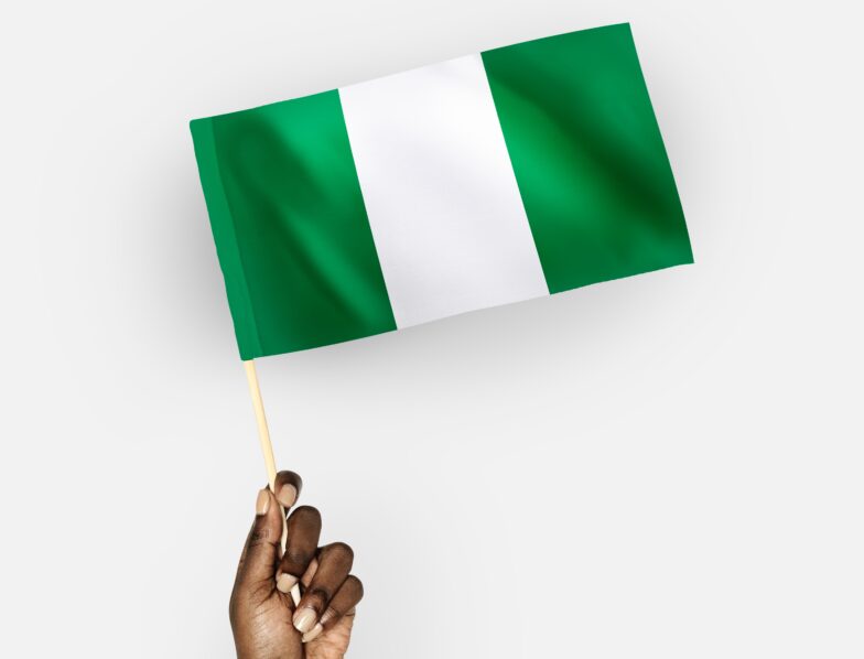 Person waving the flag of Federal Republic of Nigeria